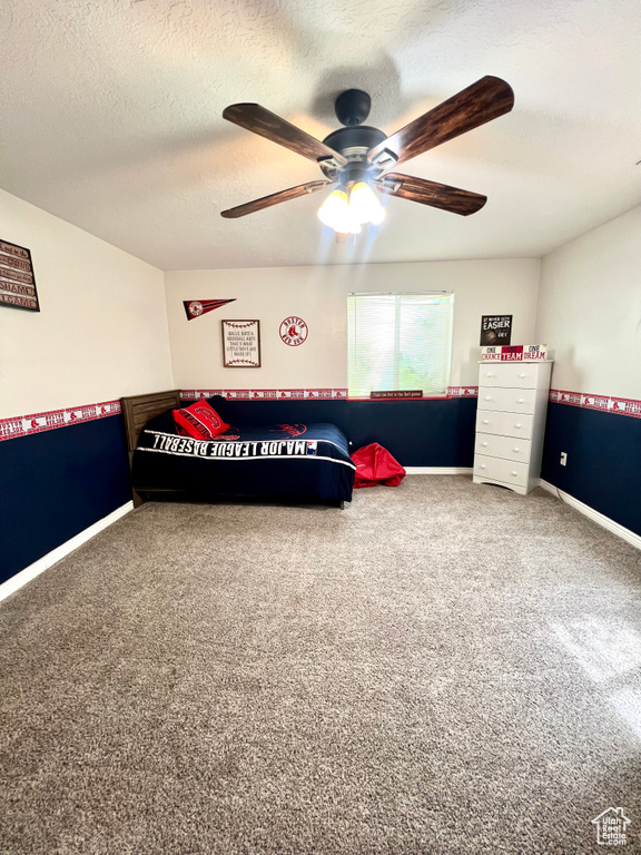 Bedroom featuring carpet, a textured ceiling, and ceiling fan