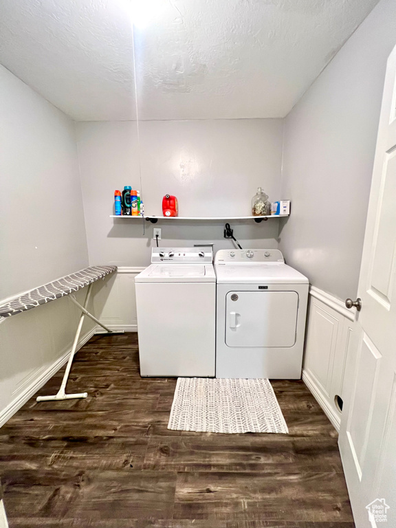 Washroom featuring separate washer and dryer and dark wood-style floors
