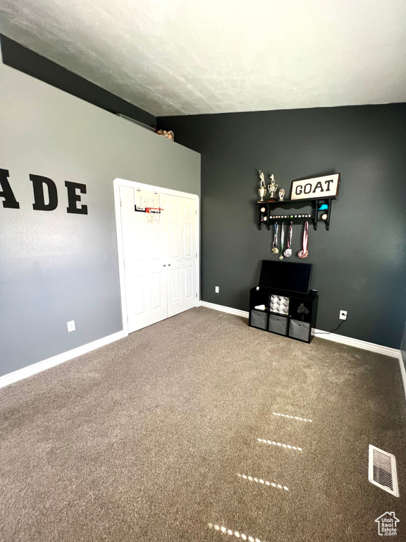 Empty room featuring carpet and baseboards