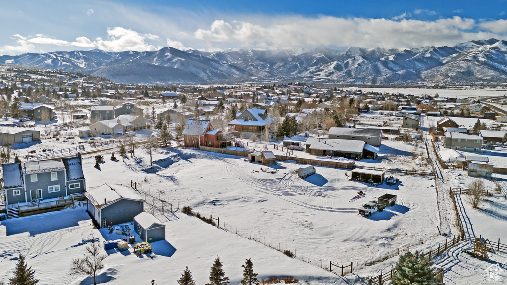 Snowy aerial view featuring a residential view and a mountain view