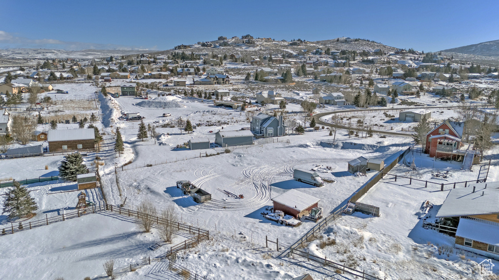 Snowy aerial view featuring a residential view