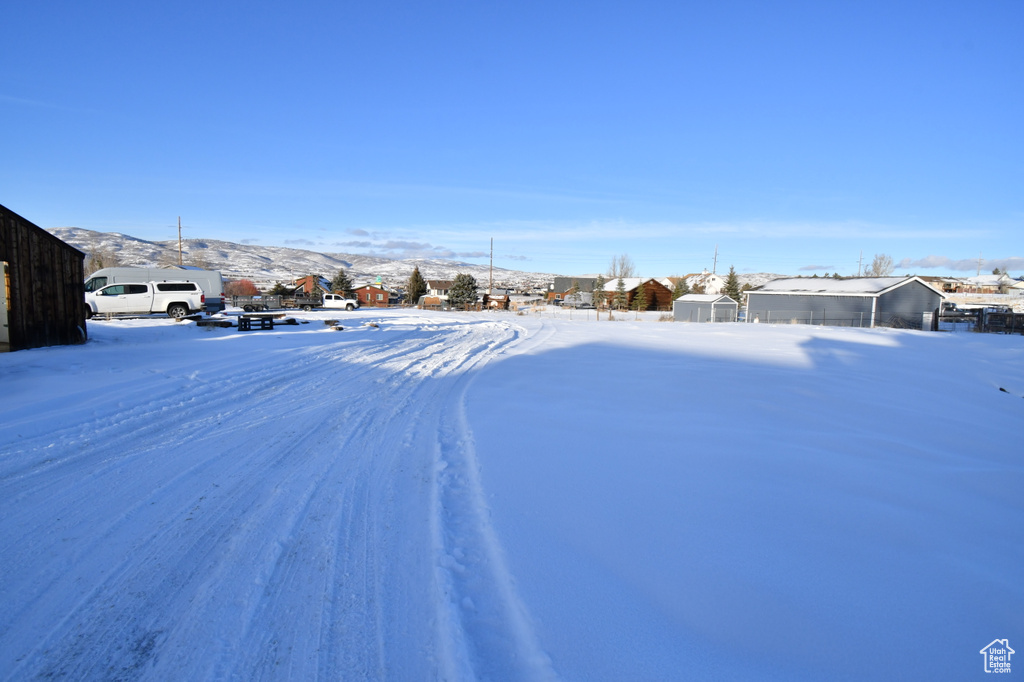 Snowy yard featuring a mountain view