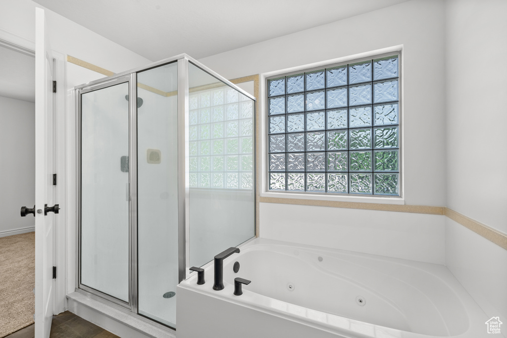Bathroom featuring a shower stall and a whirlpool tub