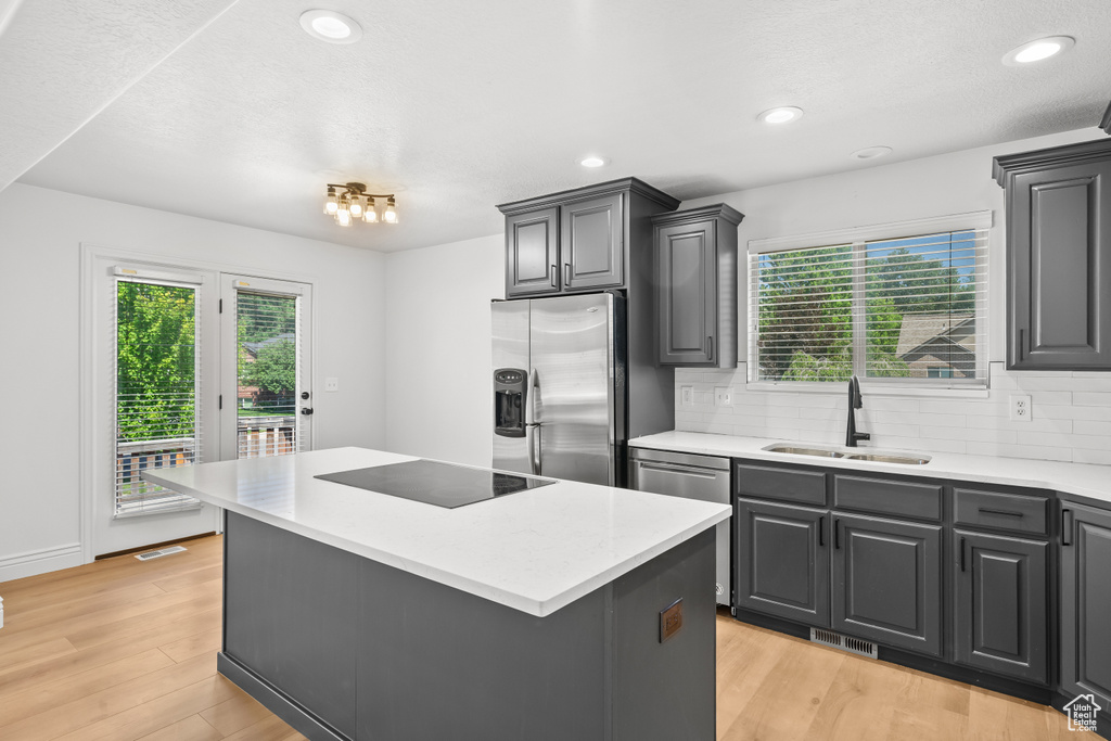 Kitchen featuring stainless steel appliances, healthy amount of natural light, decorative backsplash, and recessed lighting