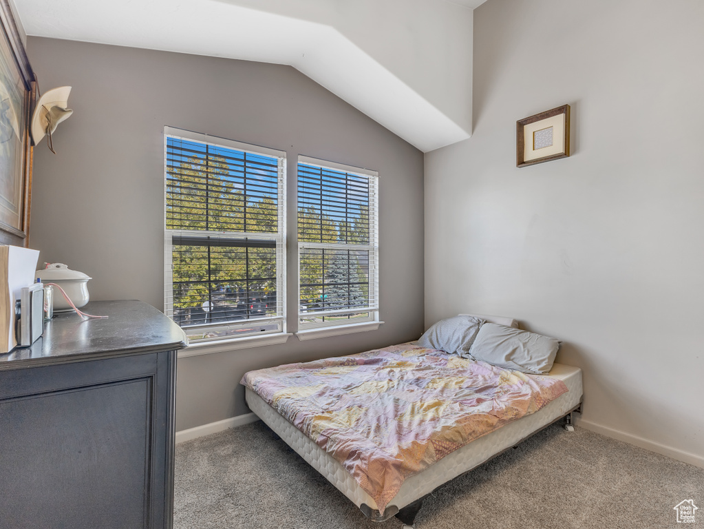 Bedroom with carpet and vaulted ceiling