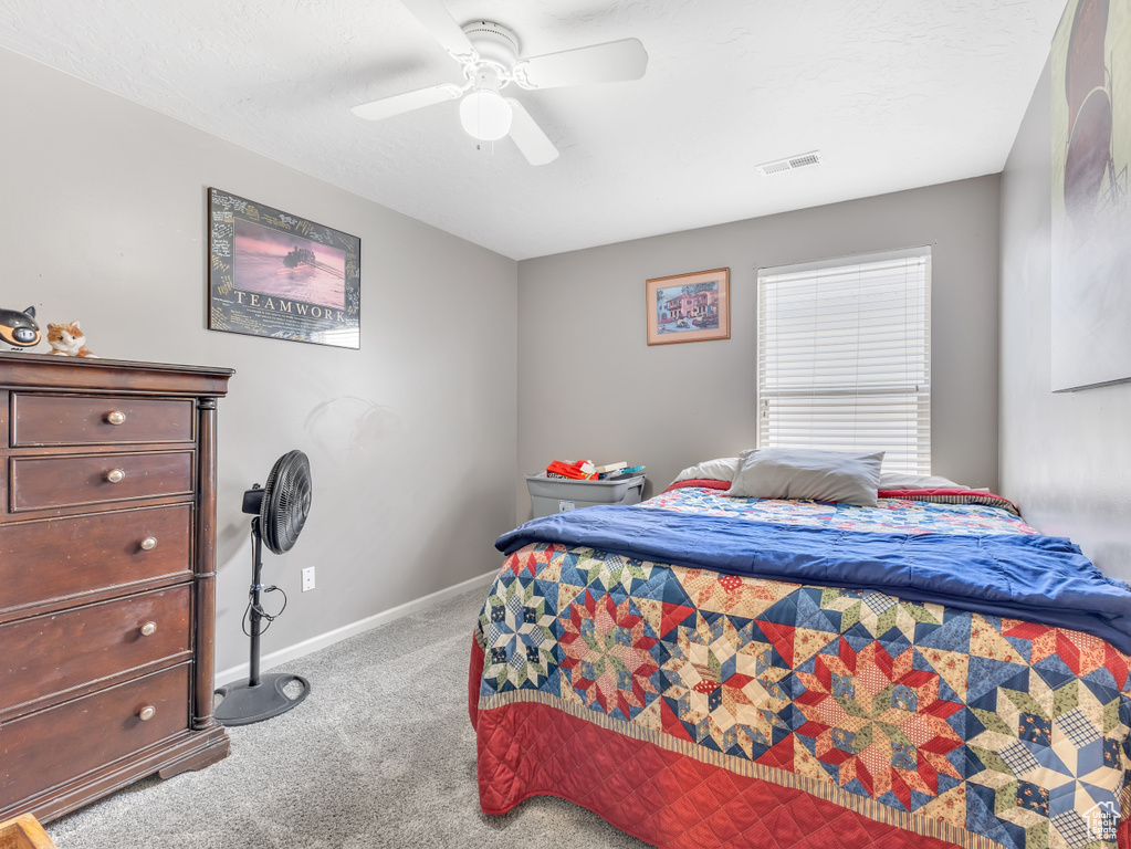Bedroom with carpet and a ceiling fan