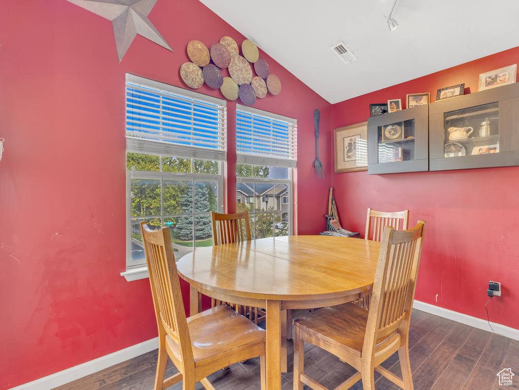 Dining room with vaulted ceiling and wood finished floors