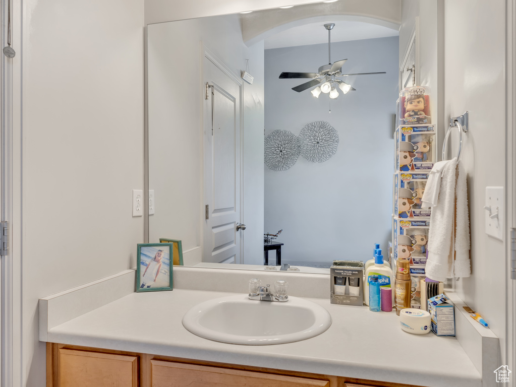 Bathroom with a ceiling fan and vanity