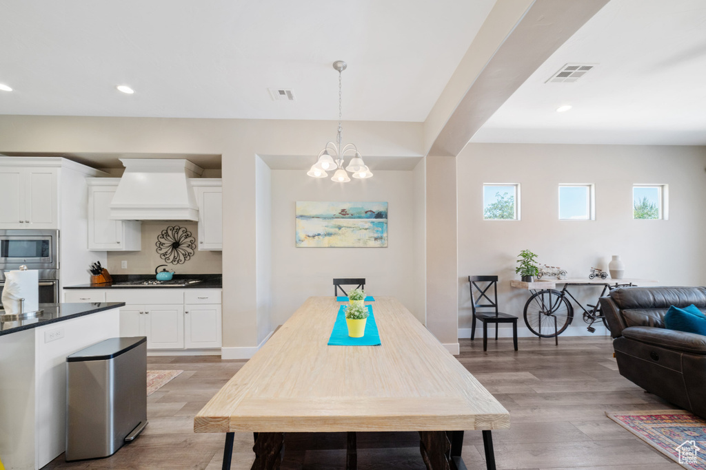 Dining space featuring a chandelier, light wood-type flooring, and recessed lighting