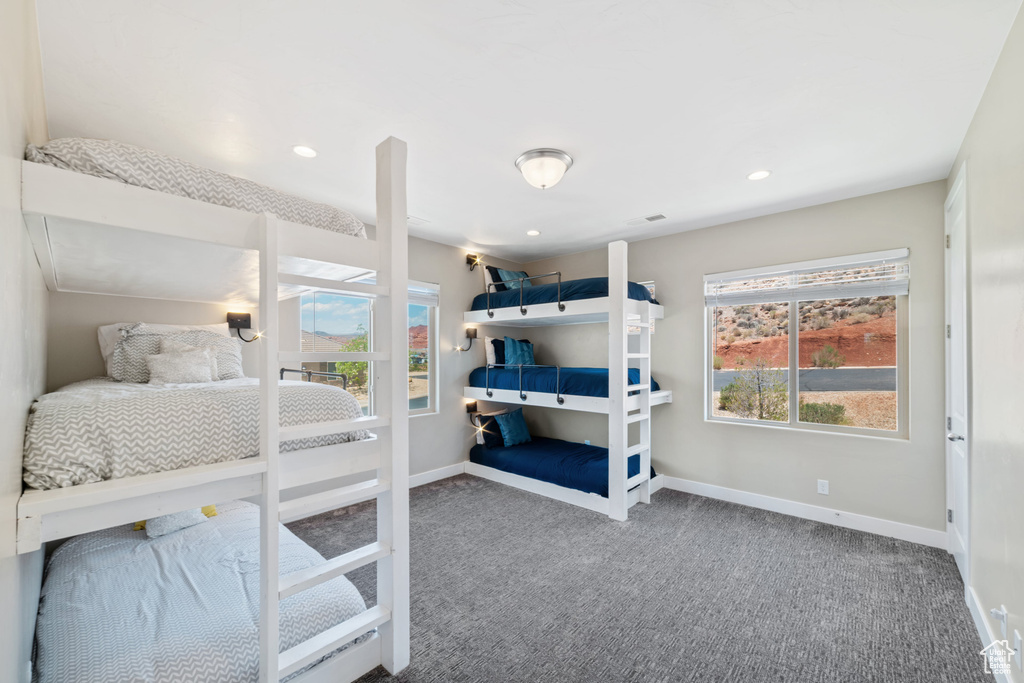 Carpeted bedroom with baseboards and recessed lighting