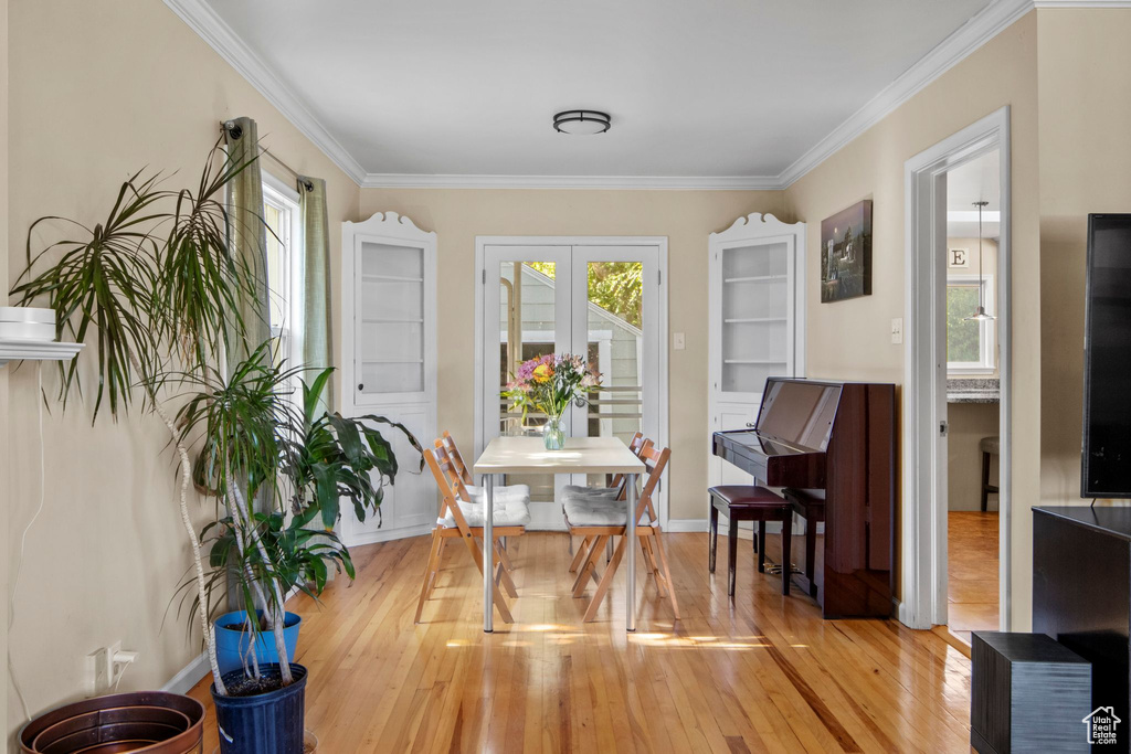 Living area with light wood finished floors and crown molding
