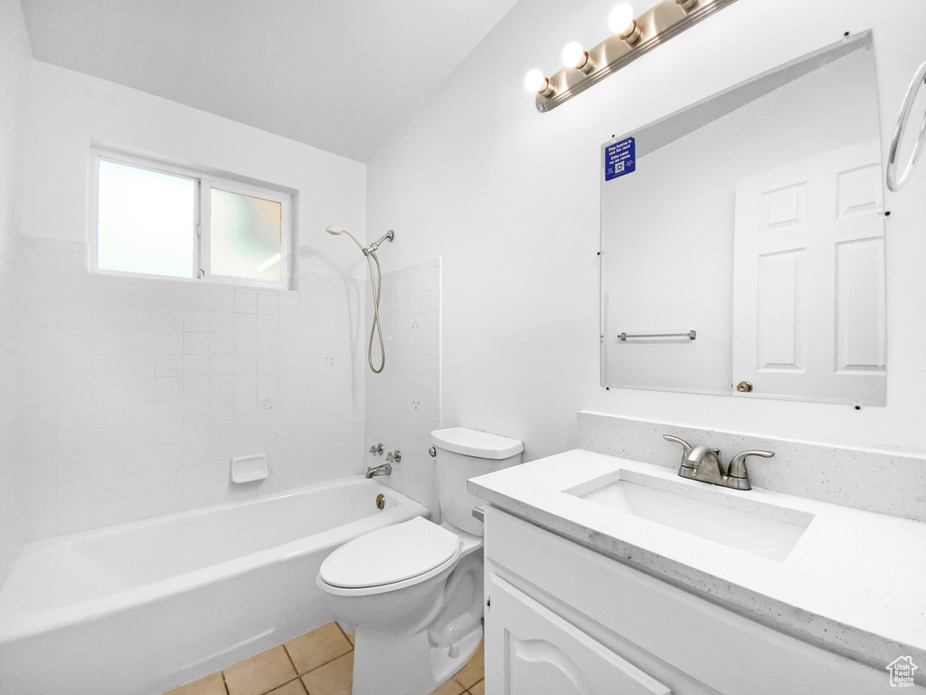 Bathroom featuring vanity, washtub / shower combination, and tile patterned floors