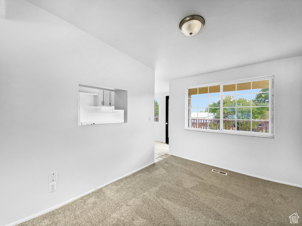 Empty room featuring carpet flooring and baseboards