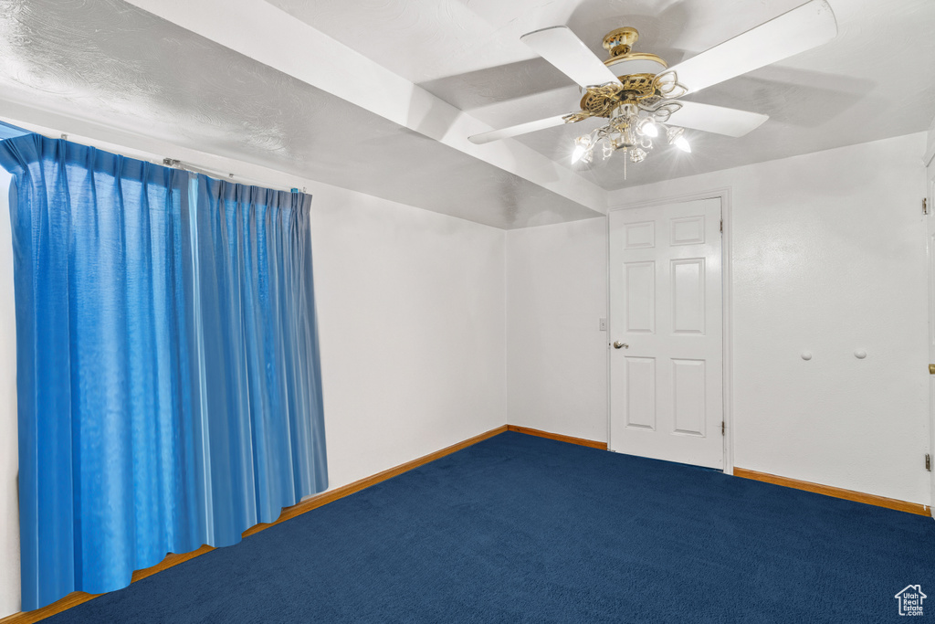 Empty room with carpet floors and ceiling fan