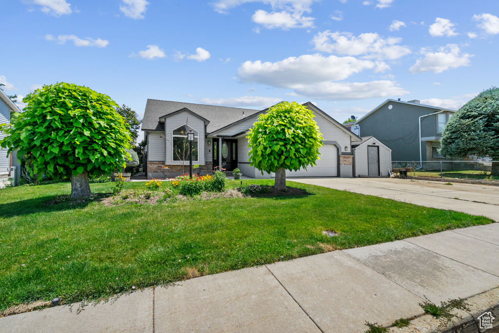 View of front of home with driveway and a garage