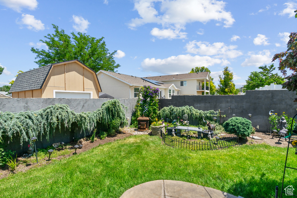 Fenced backyard featuring a garage