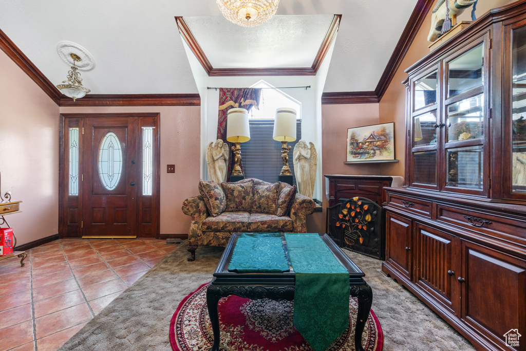Entrance foyer featuring plenty of natural light, crown molding, and tile patterned flooring