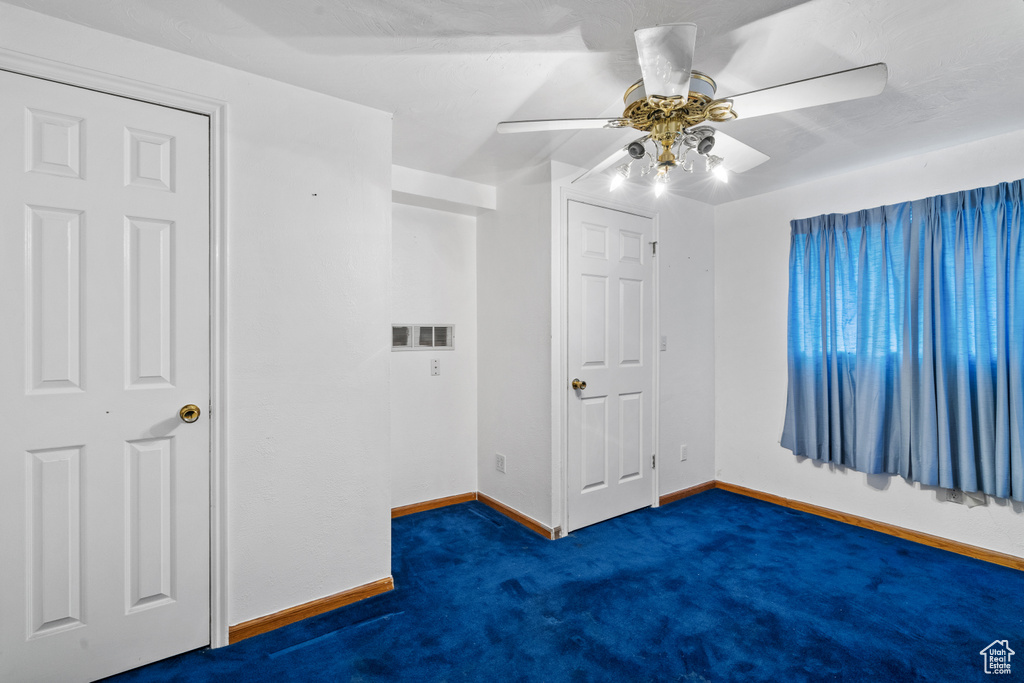 Unfurnished bedroom with carpet and a ceiling fan