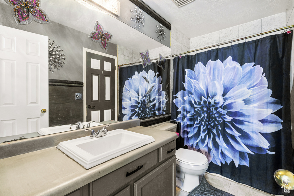 Bathroom featuring vanity, tile patterned floors, and a shower with shower curtain