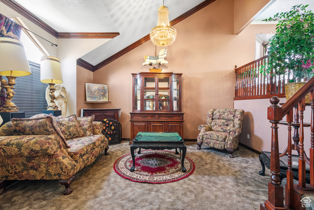 Living room with carpet floors, stairs, ornamental molding, and high vaulted ceiling