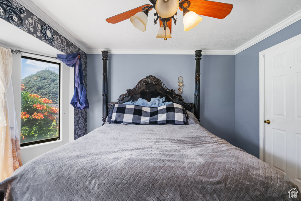 Bedroom with crown molding and ceiling fan