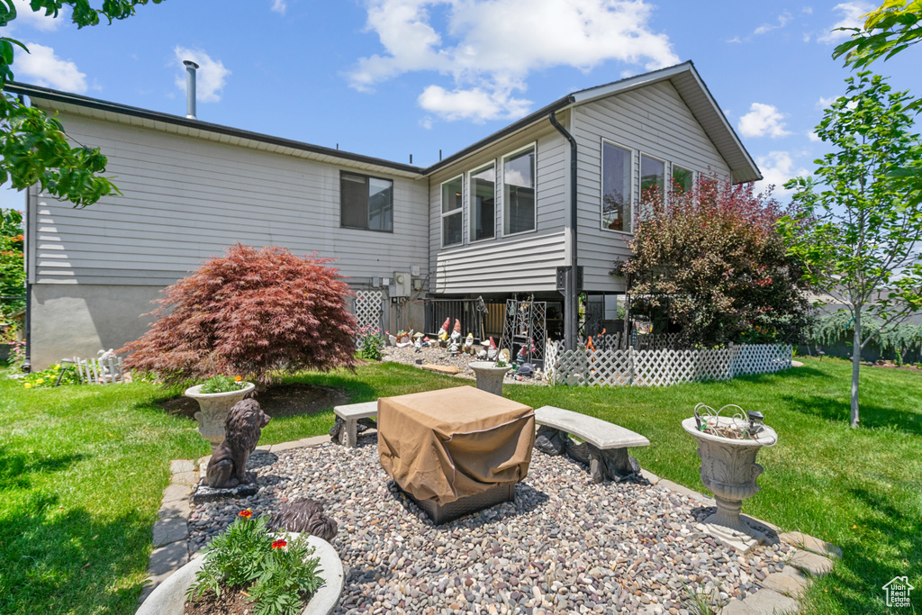 Rear view of house featuring a lawn
