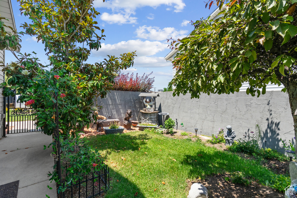 Fenced backyard featuring a gate