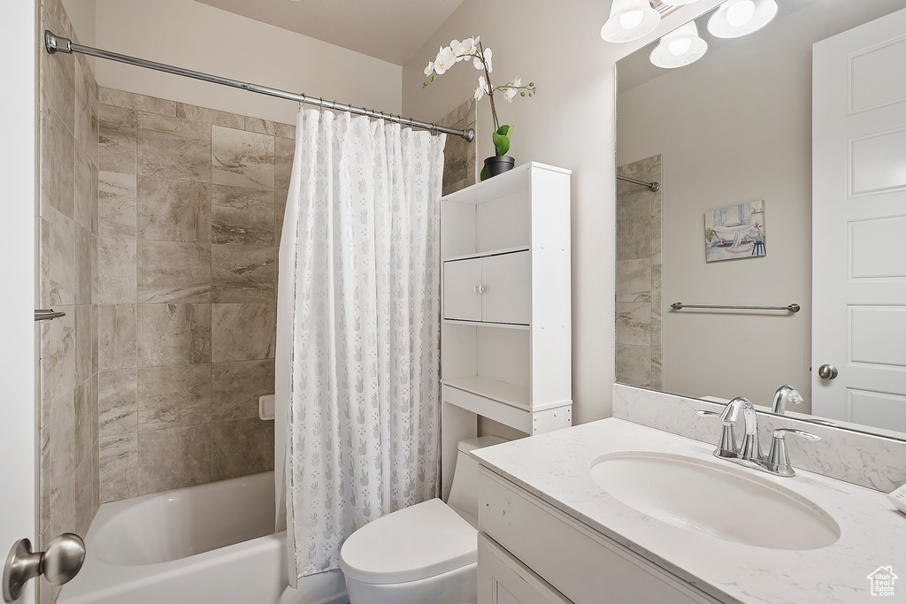Full bathroom featuring vanity and shower / bath combination with curtain