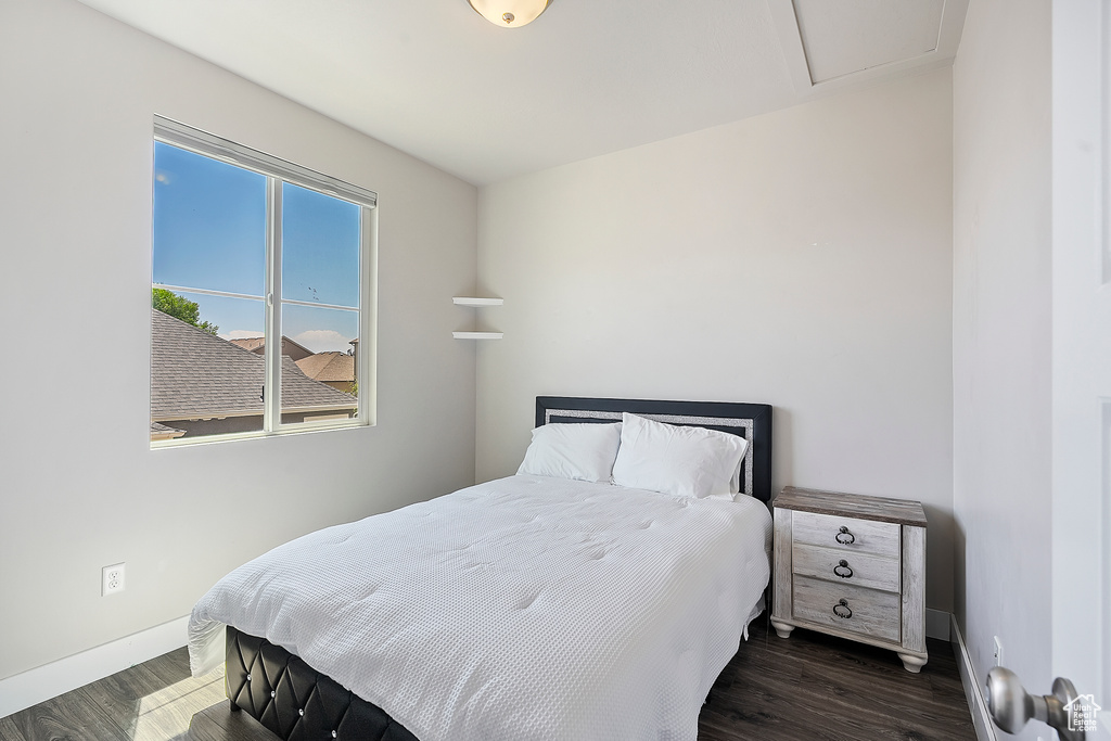 Bedroom with baseboards and wood finished floors