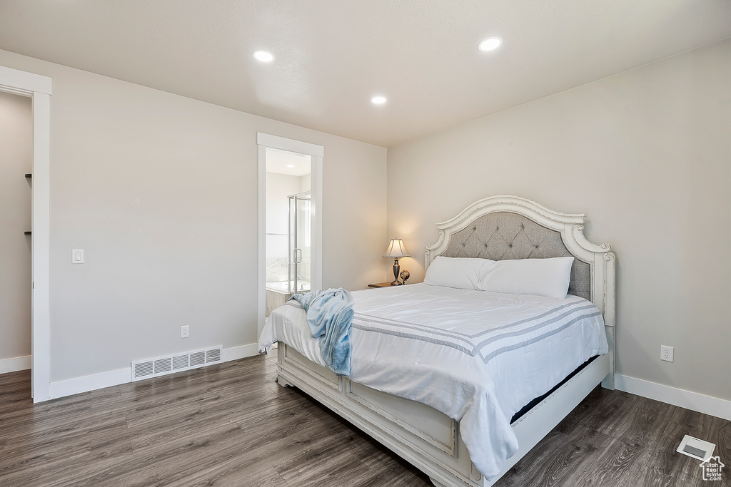 Bedroom featuring wood finished floors, recessed lighting, and ensuite bathroom