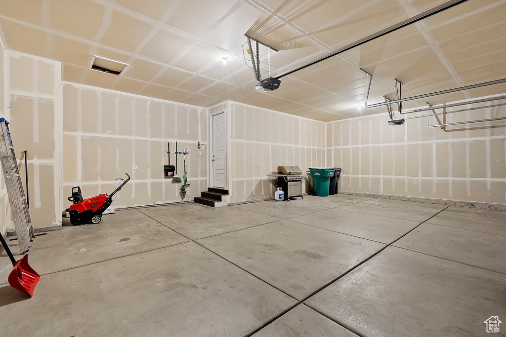 Garage featuring a garage door opener