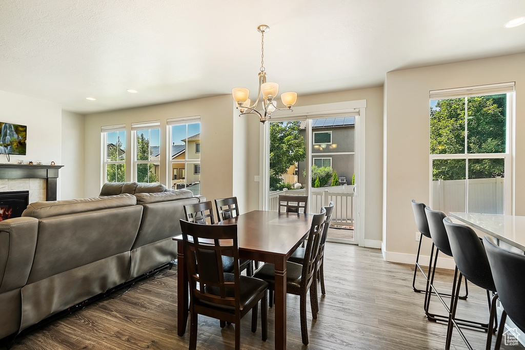 Dining area featuring a chandelier, healthy amount of natural light, dark wood finished floors, and recessed lighting