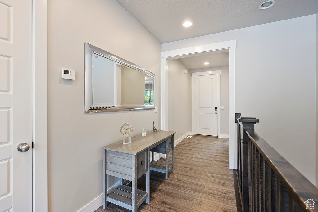 Corridor featuring wood finished floors and recessed lighting