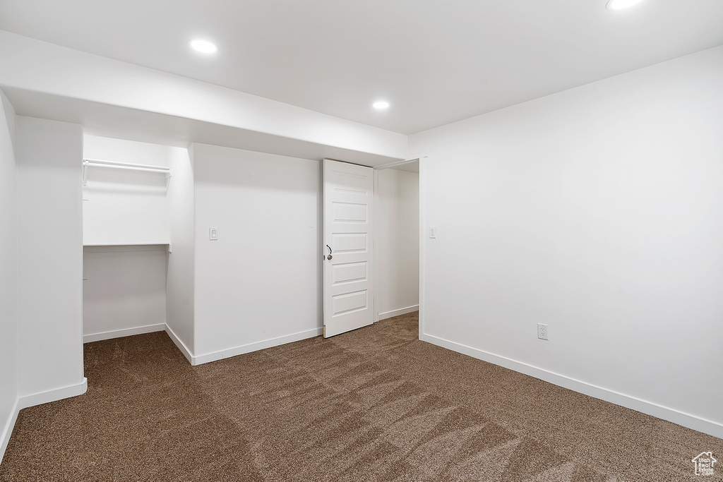 Unfurnished bedroom with carpet floors, recessed lighting, a spacious closet, and a closet