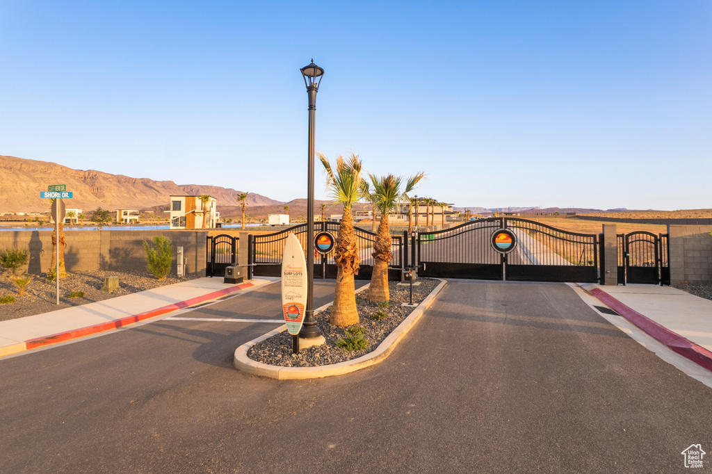 View of front of house with a gate and a mountain view