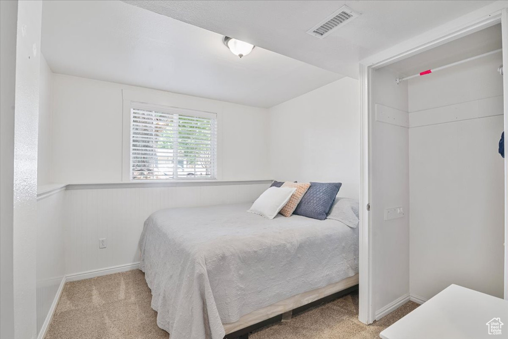 Carpeted bedroom with baseboards