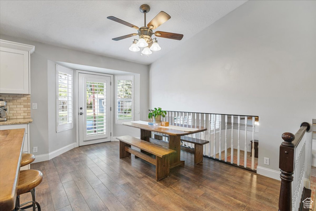 Dining room with wood finished floors and a ceiling fan