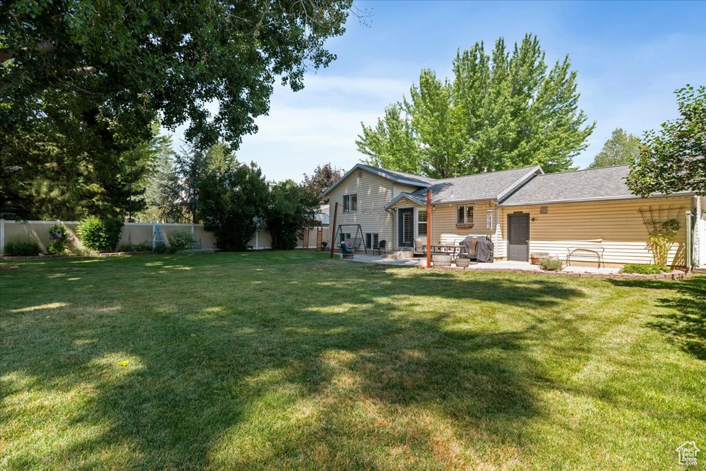 Fenced backyard with a patio area