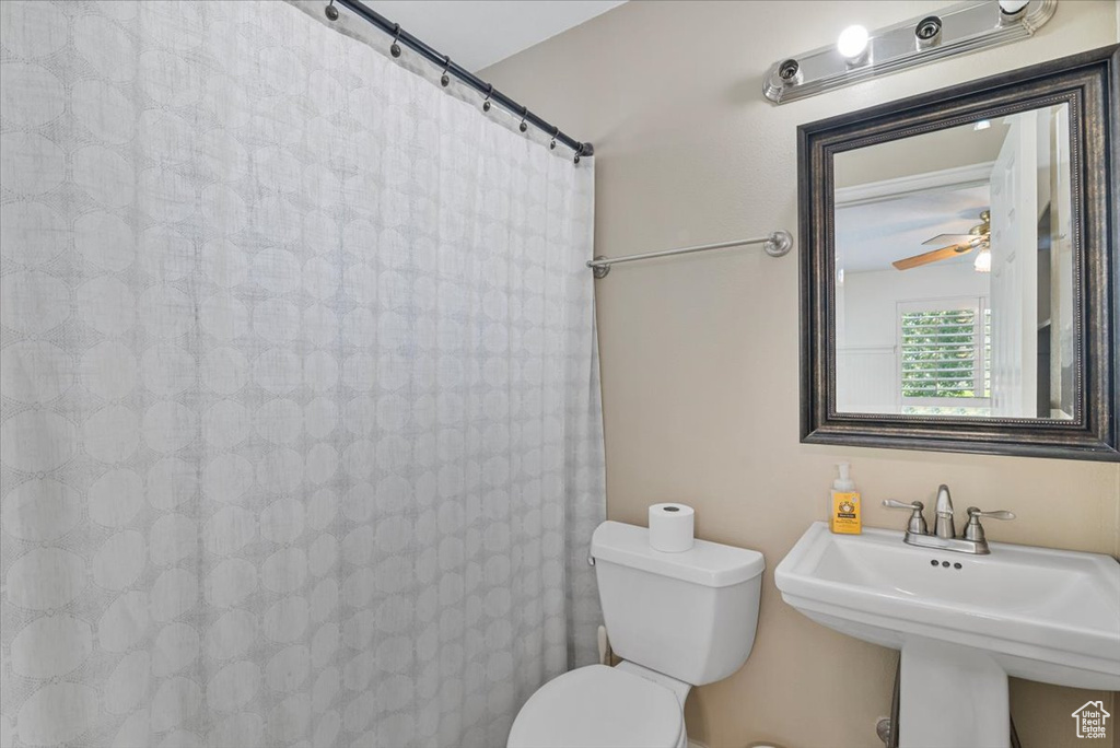 Full bath featuring toilet and a shower with curtain