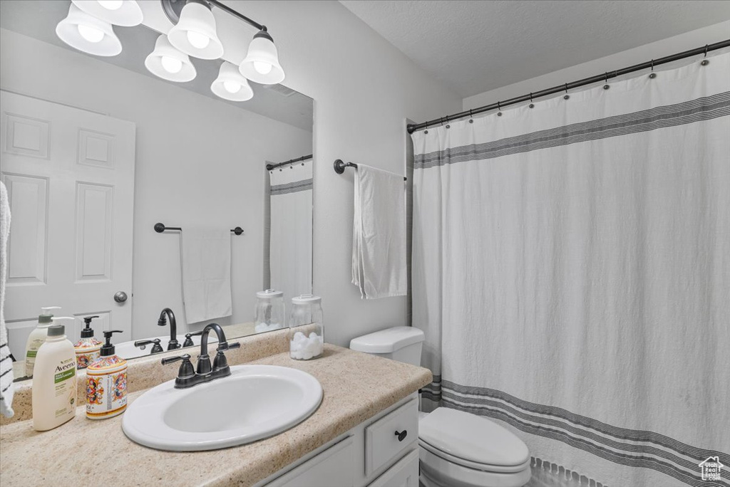 Full bath with toilet and vanity