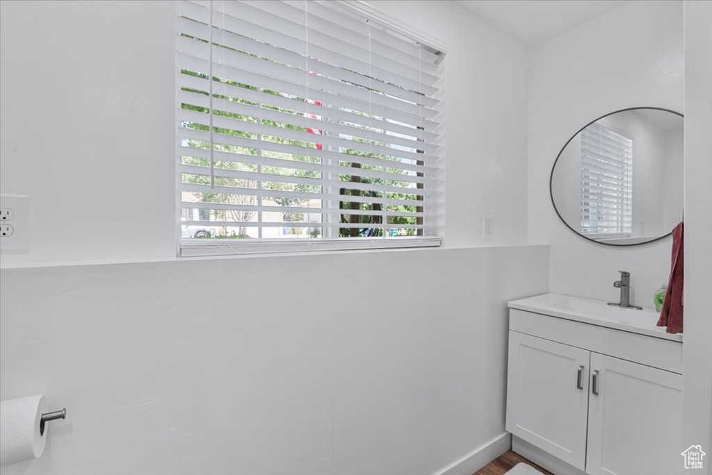 Bathroom featuring vanity and healthy amount of natural light