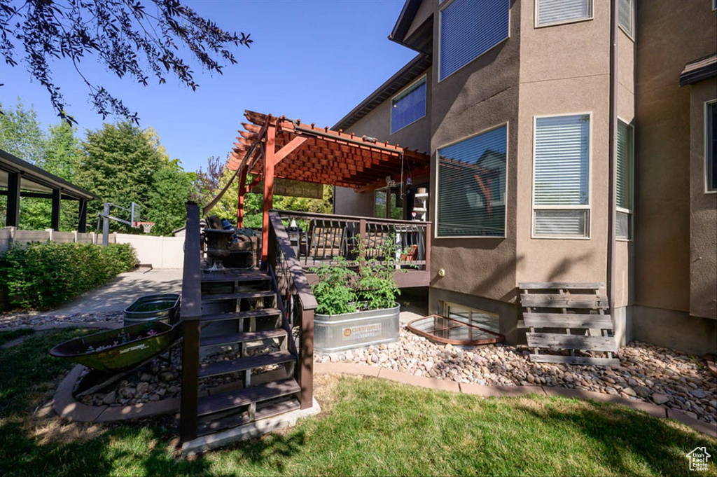 View of yard featuring a deck and a pergola