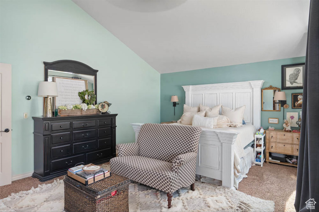 Carpeted bedroom featuring vaulted ceiling