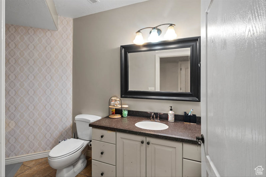 Full bath with vanity, a shower, and tile patterned floors