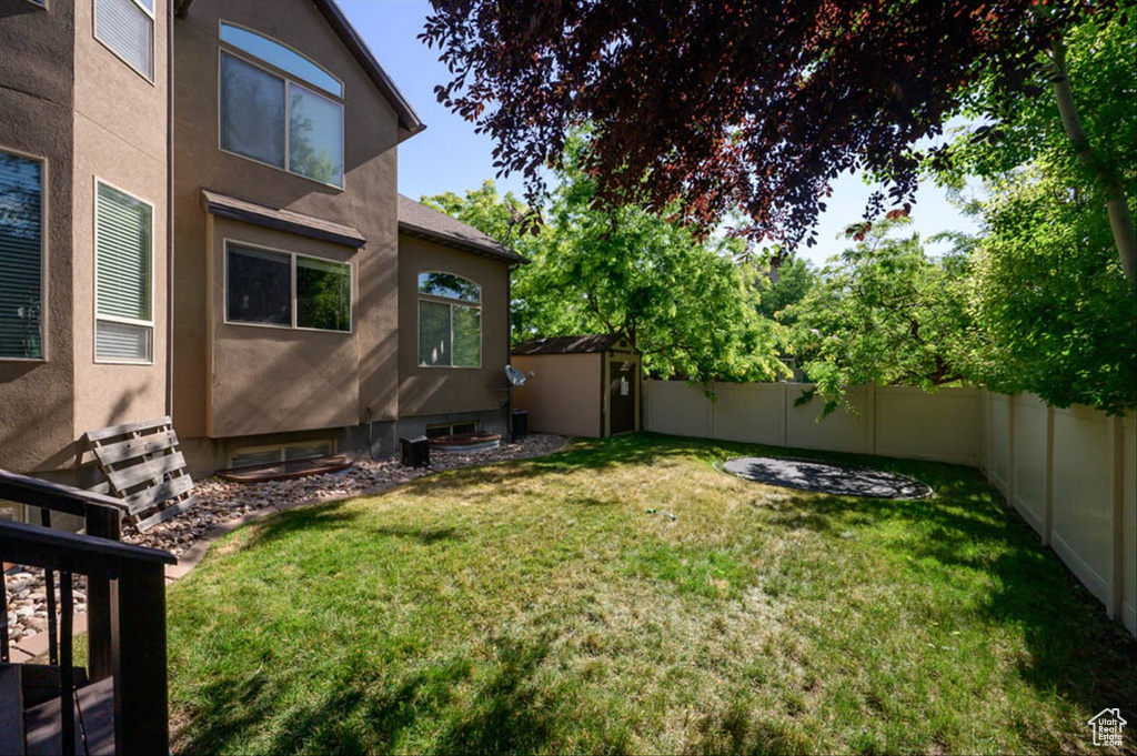 Fenced backyard with a storage unit
