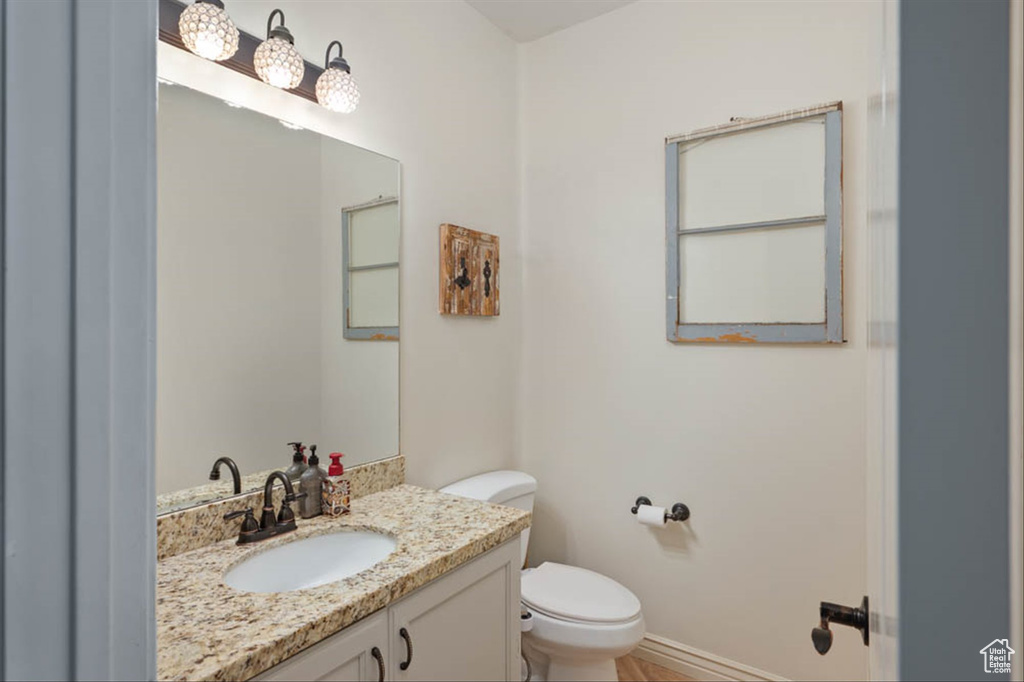 Half bath featuring toilet and vanity