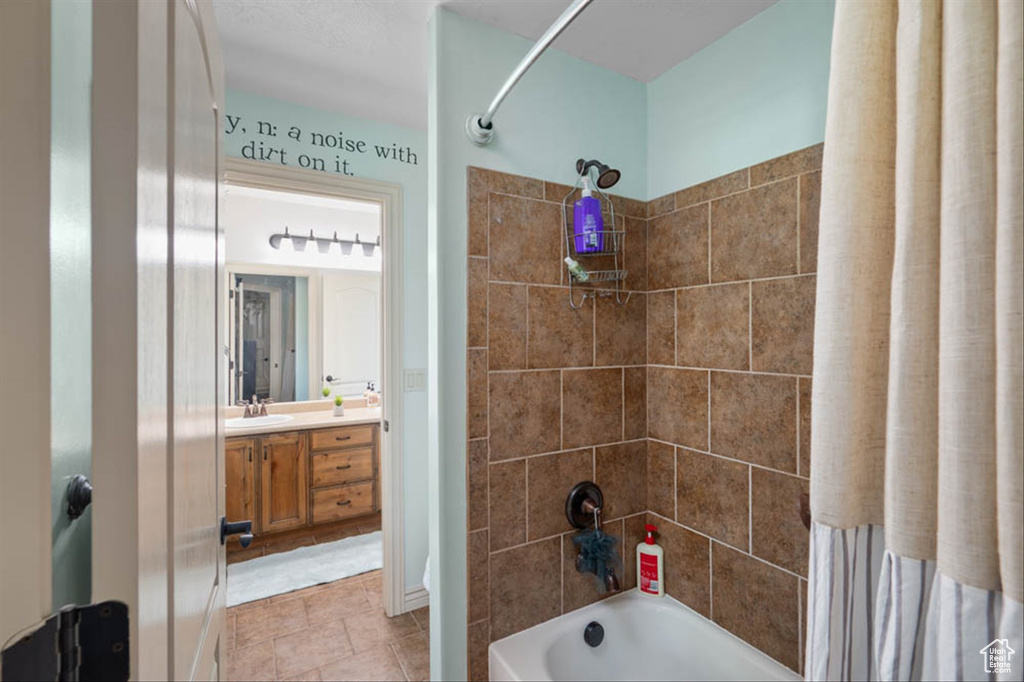 Full bath featuring shower / bathtub combination, vanity, and tile patterned floors