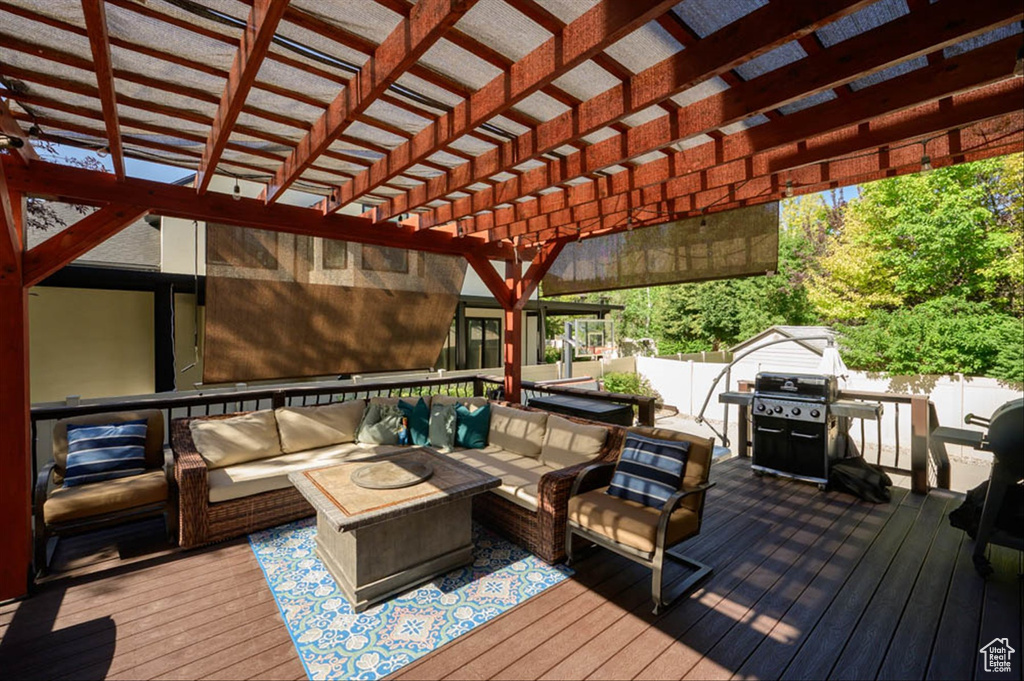 Deck featuring an outdoor hangout area, a grill, and a pergola