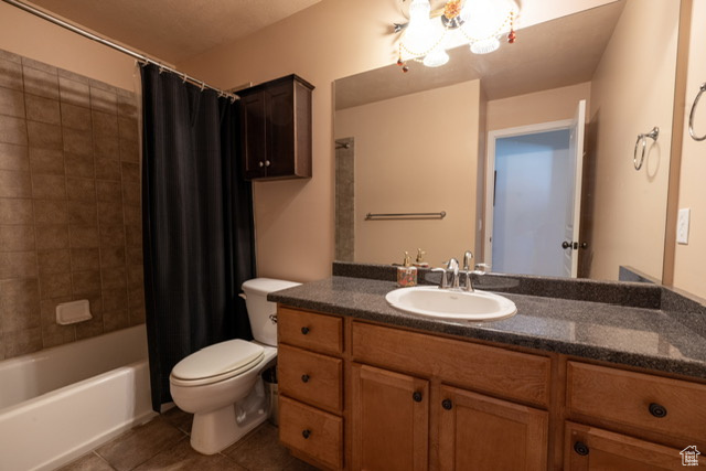 Bathroom with tile patterned flooring, vanity, and shower / bath combo
