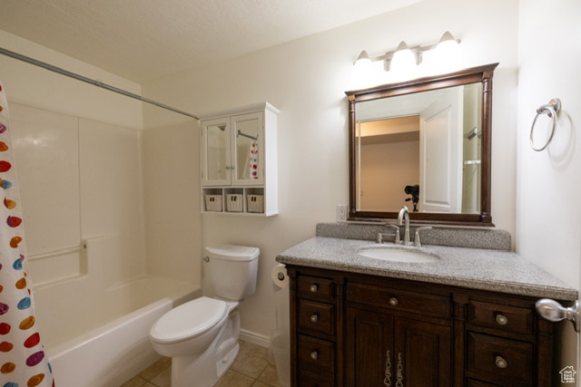 Full bath featuring vanity, tile patterned floors, and shower / bathtub combination with curtain